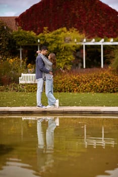 lovely young couple kissing outdoors in autumn. Loving couple walking in nature. Autumn mood. Happy man and woman hugging and kissing in autumn. Love. Fashionable couple outdoors. Fashion, people and lifestyle. Stylish couple in autumn outfit.