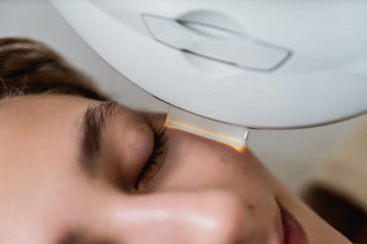 Phototherapy, photorejuvenation, IPL in a beauty salon. Care for a woman's face. High quality photo