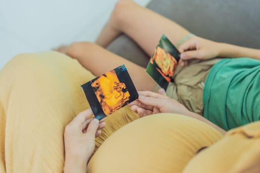 Expectant mother tenderly shares the joy of her unborn baby with her son, showing him heartwarming ultrasound photos of his soon-to-arrive little brother.