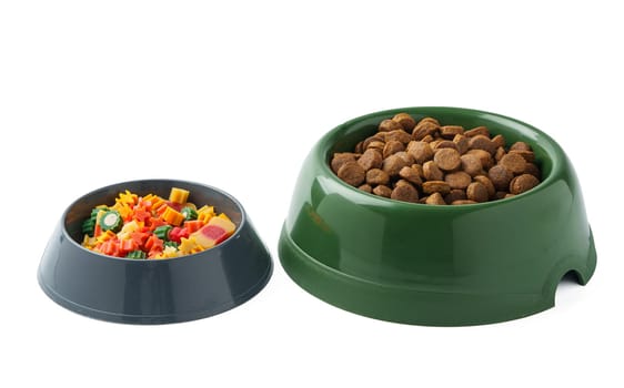 Green plastic bowl with dry pet food isolated on white background