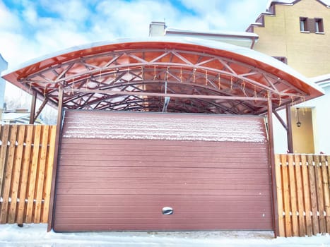 New gates to the private territory on winter day and snow. Metallic texture and background