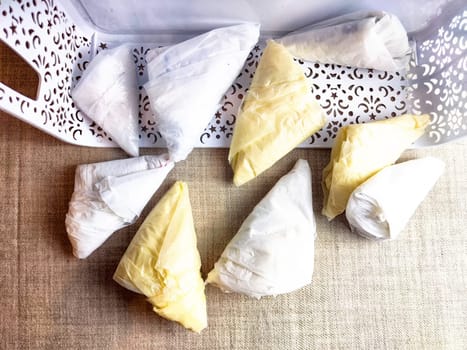 Plastic bag folded into triangle for storage. Ways of storing and laying at home