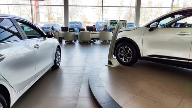 Cheboksary, Russia - April 05, 2023: Cars in showroom of dealership KIA. Re-export to Russia