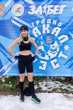 Grodno, Belarus - January 28, 2024: A woman in a swimsuit poses after finishing during the traditional annual Temper-fest race
