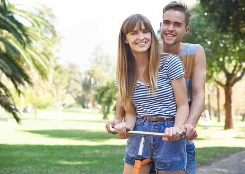 Portrait, love and couple smile on bicycle journey, outdoor wellness and romantic date in nature park. Travel, transportation and happy bonding man, woman or people ride bike on cycling trip in Spain.