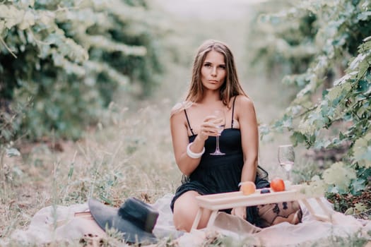 Picnic and wine tasting at sunset in the hills of Italy, Tuscany. Vineyards and open nature in the summer. Romantic dinner, fruit and wine.