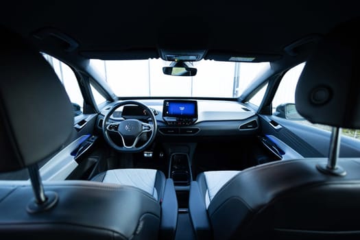 Lviv, Ukraine - October 8 2023: Volkswagen ID.3 Pro S electric car interior details with front seats, driver and passenger, textile, multimedia, console, gear shift, buttons, digital speedometer.