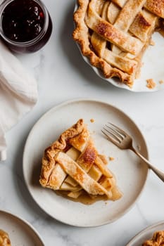 Top view of slices of delicious apple pie served on white table.