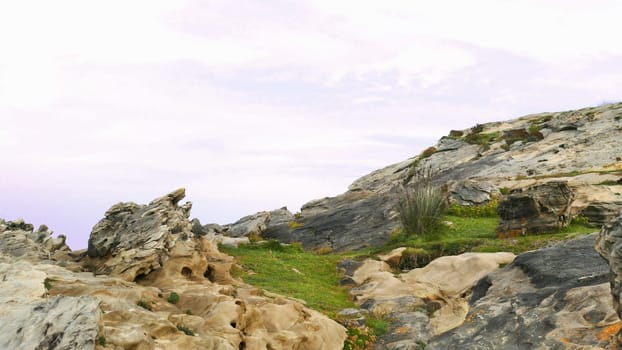 Mount with grass and limestone on the coast of the sea