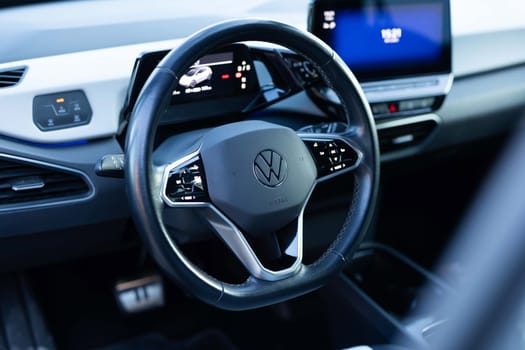 Lviv, Ukraine - October 8 2023: Volkswagen ID.3 all electric hatchback car interior. Volkswagen electric car Interior view of the steering wheel, digital screen and instrument panel in the cabin.