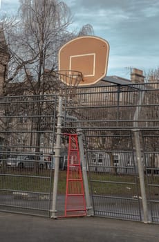 Edinburgh, Scotland, Jan 19, 2024 - Basketball backboard with the hoop metal ring in outdoor basketball courts at the city downtown. Space for text, Selective focus.