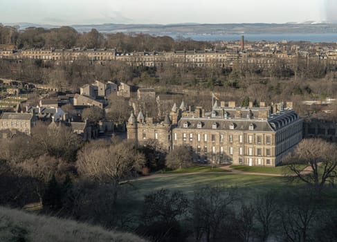 Edinburgh, Scotland - Jan 17, 2024 - Amazing Edinburgh Cityscape with Palace of Holyroodhouse and Holyrood Park seen from the top of Salisbury Crags. Destinations in Europe, Space for text, Selective focus.