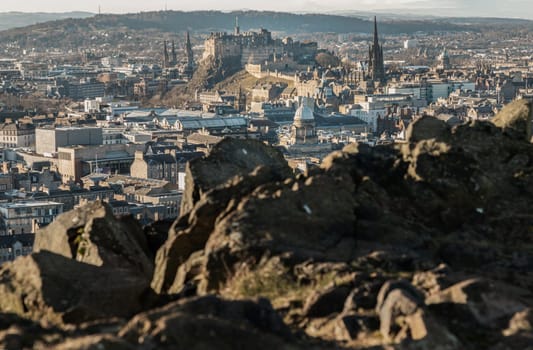 Edinburgh, Scotland - Jan 17, 2024 - Amazing Edinburgh Cityscape and Edinburgh Castle seen from the top of Salisbury Crags. Destinations in Europe, Copy space, Selective focus.