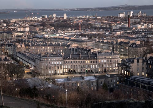 Edinburgh, Scotland - Jan 18, 2024 - Cityscape view of Edinburgh towards Leith Docks and the Firth of Forth from Calton Hill in central Edinburgh. Destinations in Europe, Space for text, Selective focus.