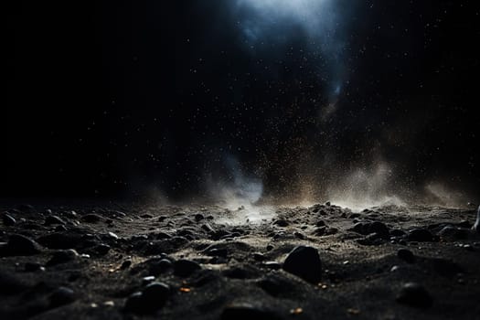 Abstract dark background with sparkles on the sand and golden bokeh in the rays of cold light.