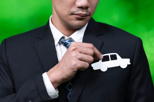 Businessman holding EV car icon symbolize eco-friendly business corporation committed to environmentally friendly transportation and zero CO2 emission. Corporate responsible and EV technology. Gyre