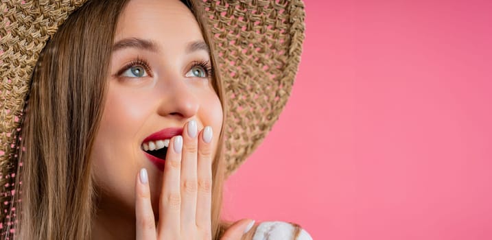 Amazed woman, she expresses WOW. Impressed teenager trying to get attention. Concept of sales, profitable offer. Excited romantic girl on pink background. High quality