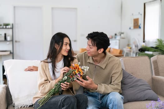 Young couple Hug and giving flower on Valentine's Day. Romantic day together. Valentine's Day concept.