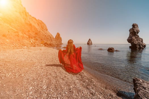 woman sea red dress Happy woman in a flying red dress and with long hair, runs on the seashore.