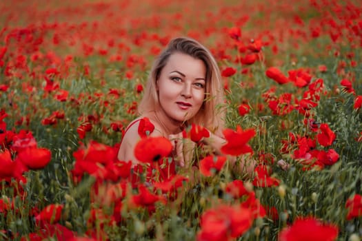 Happy woman in a red dress in a beautiful large poppy field. Blond sits in a red dress, posing on a large field of red poppies.