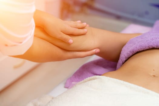 Blonde massage therapist massaging a woman. Woman getting a massage at the spa.