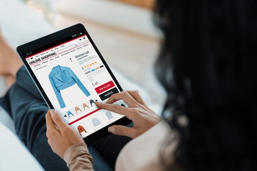 Woman shopping online on internet marketplace browsing for sale items for modern lifestyle and use credit card for online payment from wallet protected by crucial cyber security software