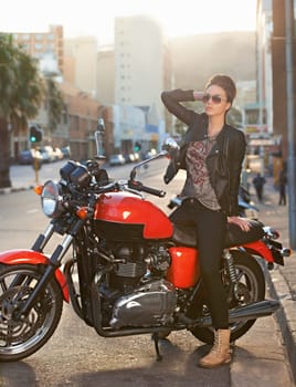 Bike, fashion and woman in city with sunglasses for travel, transport or road trip as rebel. Leather, asphalt and model with attitude on classic or vintage motorcycle for transportation or journey.