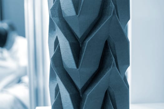 Art object vase printed on a 3D printer. Models created by a 3D printer from blue molten plastic. Concept 3d printing. Additive progressive technologies. New modern technology for creating objects
