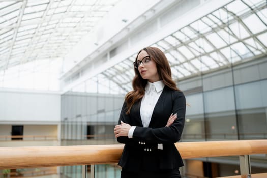 Mature business woman looking at the camera in a workplace meeting area.