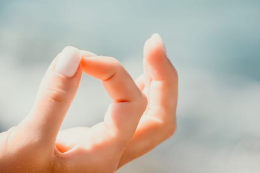 Close up Hand Gesture of Woman Doing an Outdoor Lotus Yoga Position. Close up. Blurred background