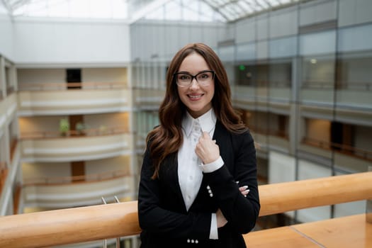 Mature business woman looking at the camera in a workplace meeting area.