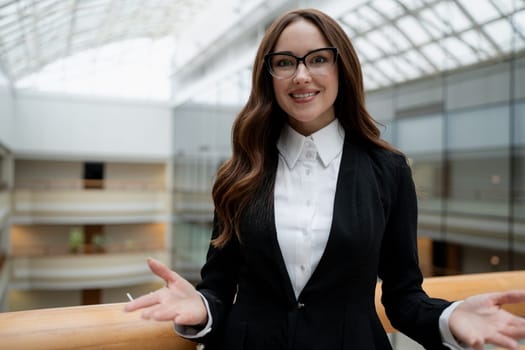 Mature business woman looking at the camera in a workplace meeting area.