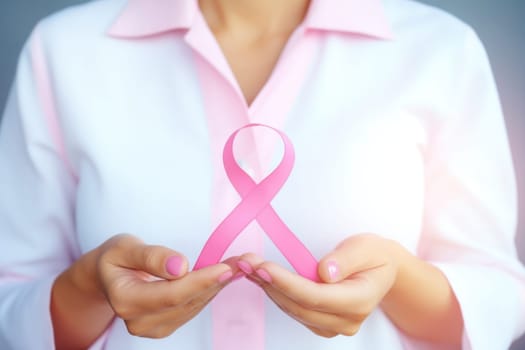 Close up of hands and pink cancer awareness ribbon. Generative AI.