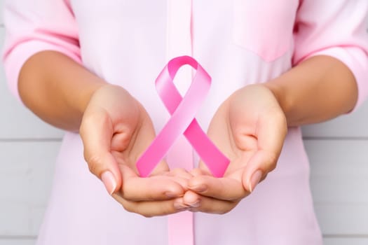 Close up of hands and pink cancer awareness ribbon. Generative AI.