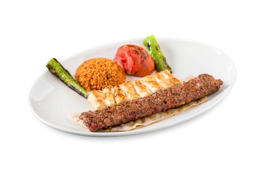 Turkish Adana Kebab with Vegetables on the Plate on white background