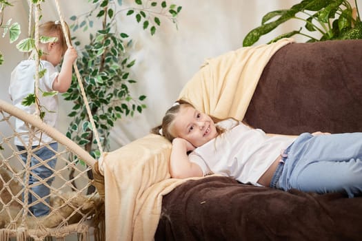 Happy time concept. Girls Sisters in chair and having fun. Female Preschooler and teenager playing and relaxing in room