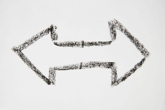 Double sided Thick smooth Hand drawn black chalk arrow. Concept of business, choosing direction, moving forward. Abstract sign, background, texture. Blurred