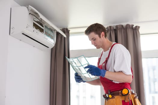 Service man is cleaning, repair and maintenance of air conditioner.