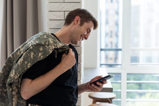 Young soldier communicating at home