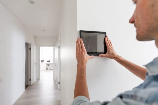 automation, internet of things and technology concept - man looking at tablet pc computer at smart home. High quality photo