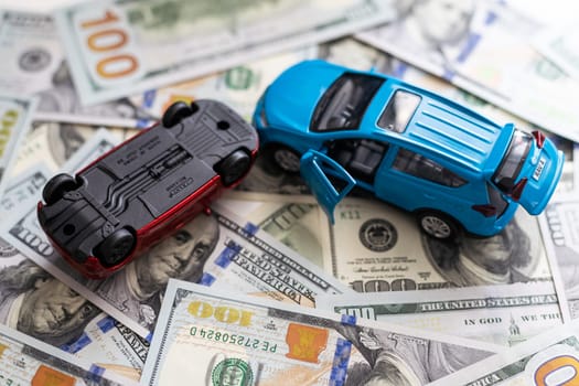 Accident between two toy cars on the background of dollar bills. High quality photo