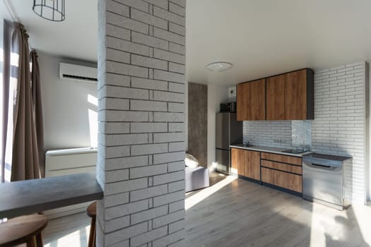 Modern living room and kitchen in small apartment.