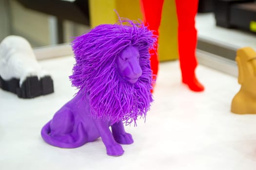 Art object model of lion printed on 3D printer. Lion toy created by 3D printing from molten plastic. Example of creating prototype by 3D printer. Concept 3D printing. 3D printing innovation technology