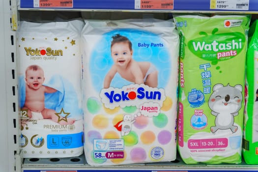 Tyumen, Russia-November 25, 2023: Buying baby diapers pants YokoSun in the supermarket.