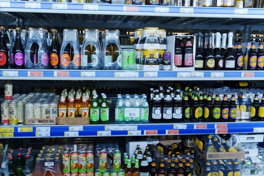 Tyumen, Russia-December 11, 2023: Shop counter. Beer in the window. Beer in bottles and tin cans. Selective focus