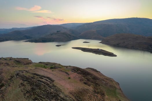 aerial drone shot Alsigarh lake Rayta bahubali aravalli hills just outside udaipur a fast growing tourist spot in the city of lakes tourist spot in Rajasthan India shot at dusk