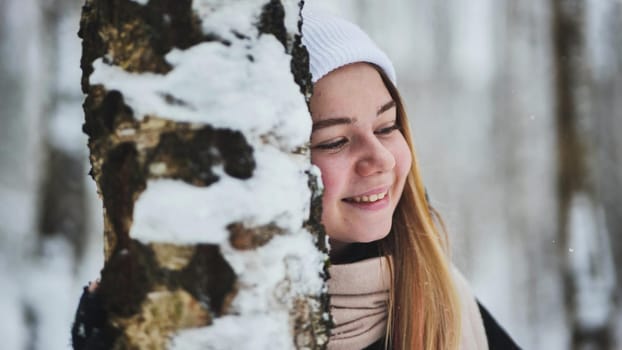 Portrait of a girl in winter in a birch forest