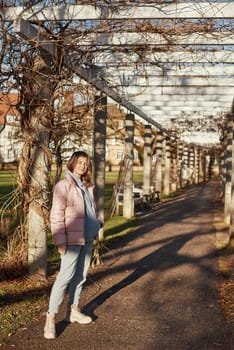 Winter Fun in Bitigheim-Bissingen: Beautiful Girl in Pink Jacket Amidst Half-Timbered Charm. Step into the festive winter spirit with this captivating image of a lovely girl in a pink winter jacket standing in the archway of the historic town of Bitigheim-Bissingen, Baden-Württemberg, Germany. The backdrop features charming half-timbered houses, enhanced by warm vintage photo processing, creating a delightful scene of winter joy and architectural beauty.