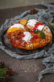 Bolo Rei or Kings Cake is a traditional Xmas cake with fruits raisins nut and icing on kitcthen countertop. Is made for Christmas, Carnavale or Mardi Gras