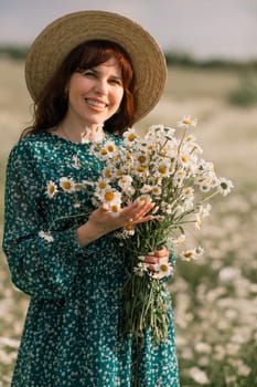 Happy woman in a field of daisies with a wreath of wildflowers on her head. woman in a green dress in a field of white flowers. Charming woman with a bouquet of daisies, tender summer photo.